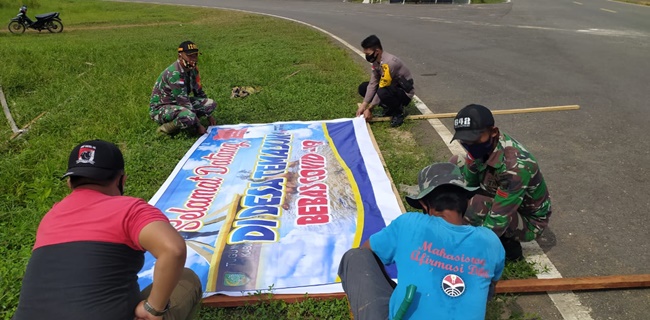 Sinergitas TNI-Polri: Kompak Pasang Spanduk Pencegahan Covid-19