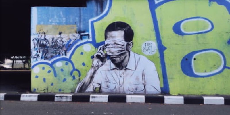 Muncul Mural Wajah Mirip Jokowi Tertutup Masker, Warganet: Jangan Sampai Faldo Maldini Tahu<i>!</i>