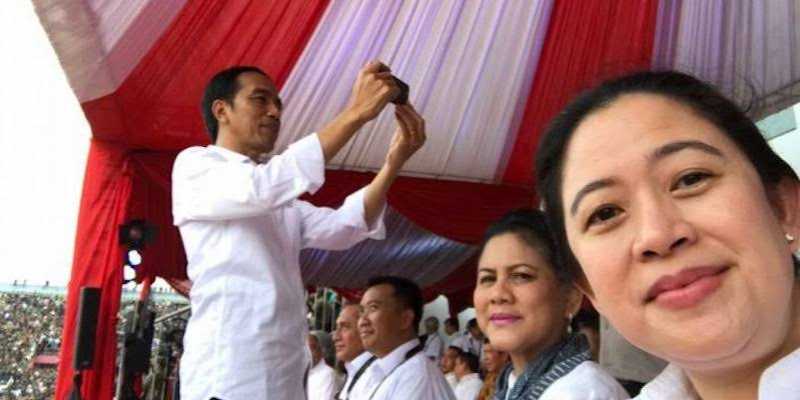 Presiden Jokowi dan Puan Maharani masing-masing melakukan selfie/Net